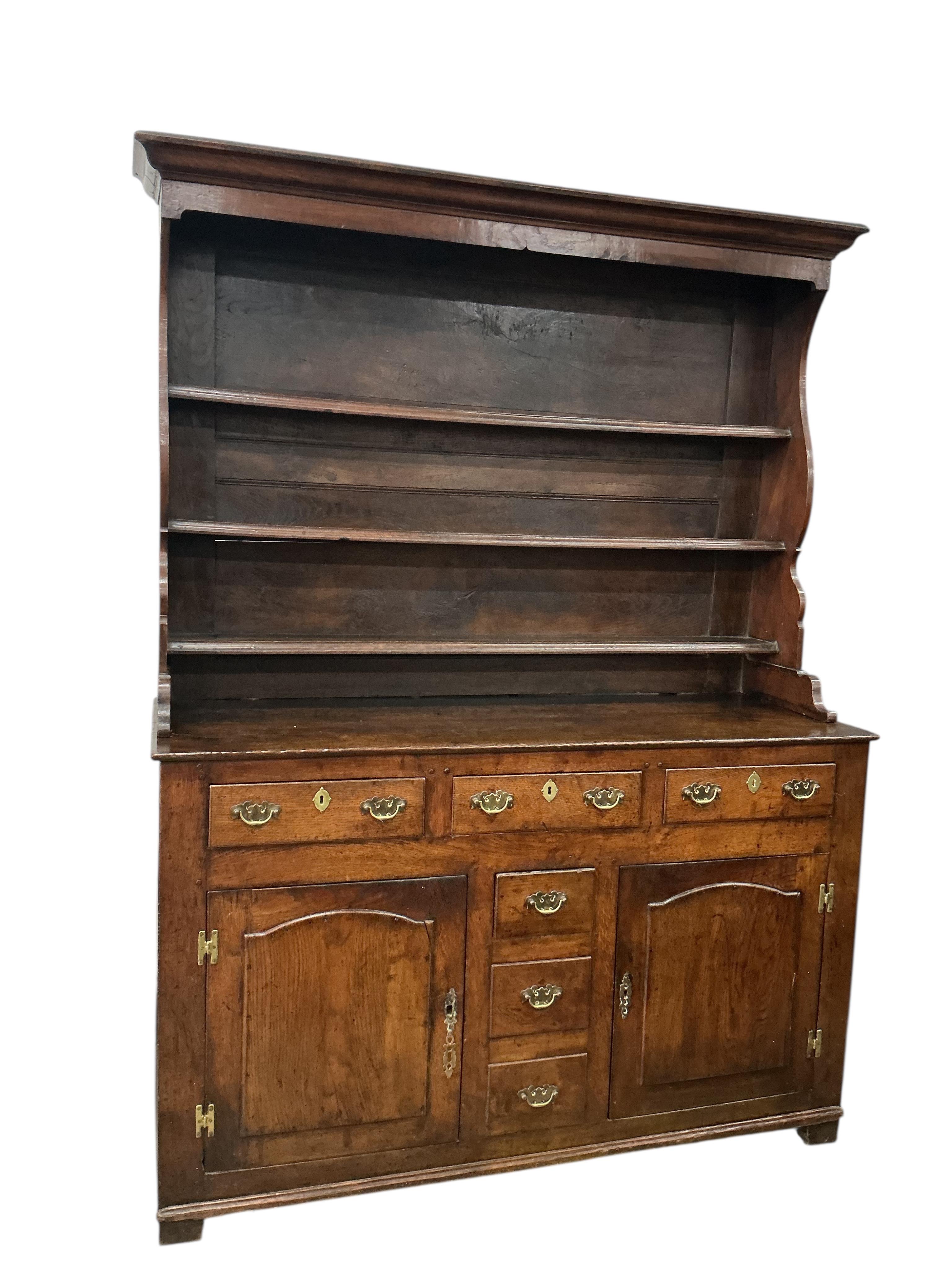 An early 18th century North Wales oak dresser, with boarded rack, width 144cm, depth 52cm, height 196cm